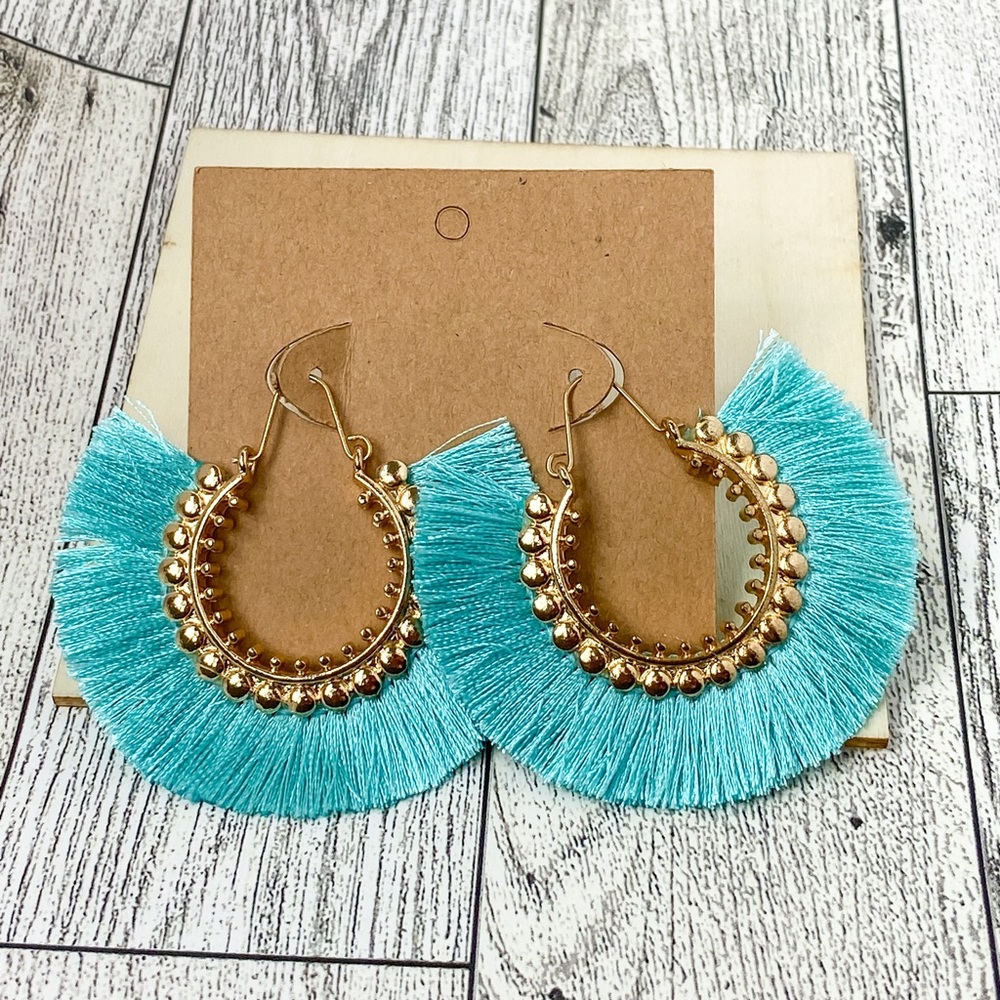 Gold light color of a greenish blue tassel earrings